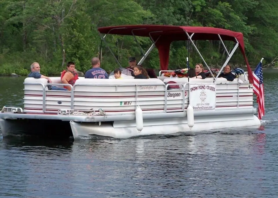 A group of people on a pontoon boat.